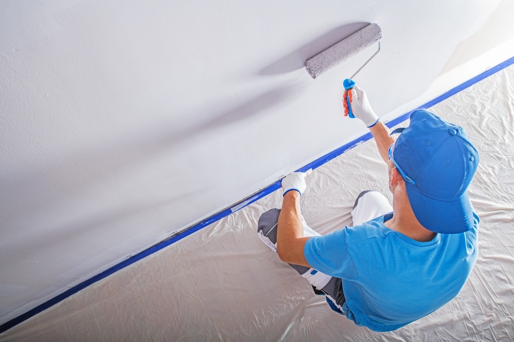 Man painting drywall. Drywall repair is a specialty from Taylor Painting Co, from start to finish.